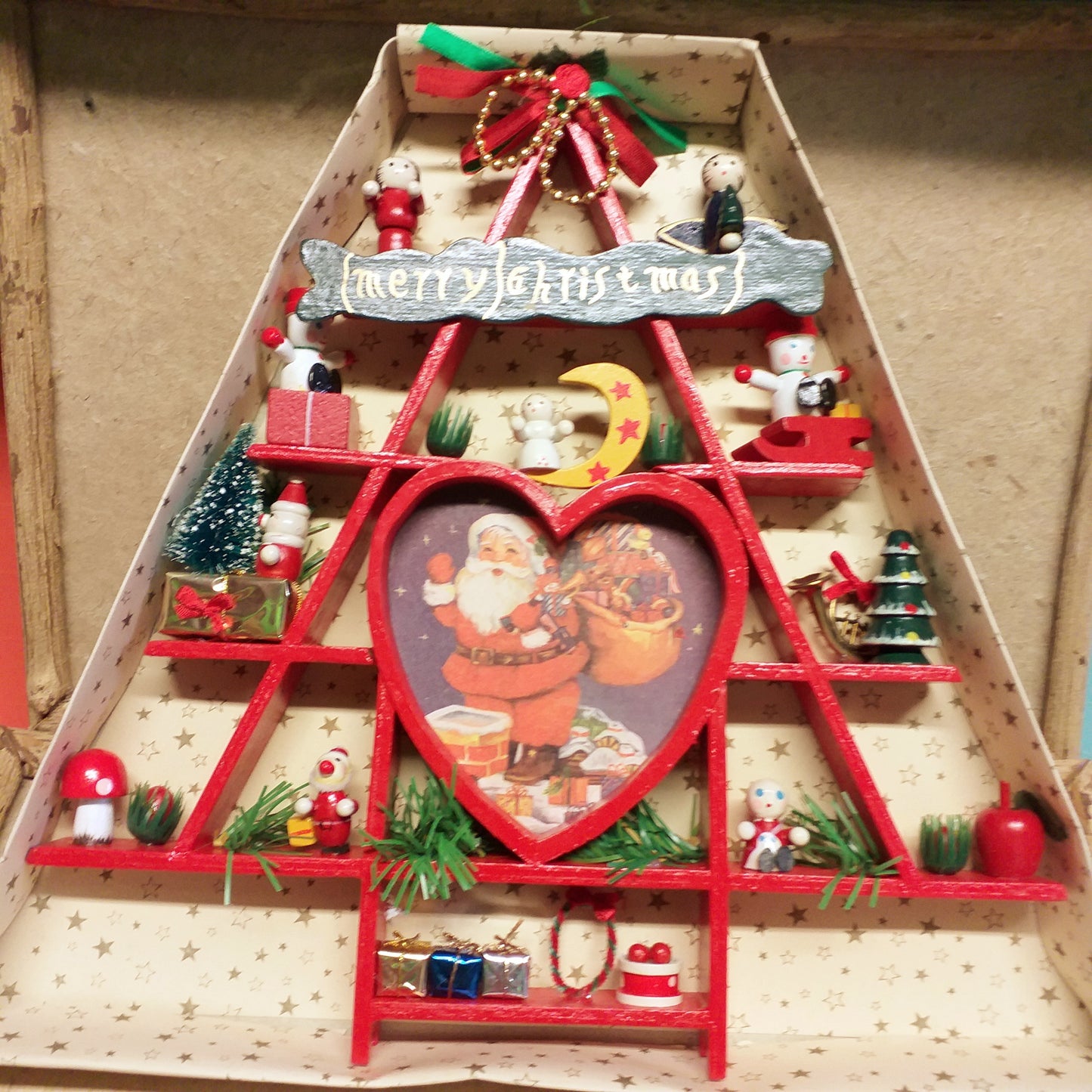 fuoriporta rustico fai da te albero legno rosso stilizzato con balocchi pacchetti regalo miniature gingilli babbo Natale Merry Christmas uso vetrinistica confezionamento packaging