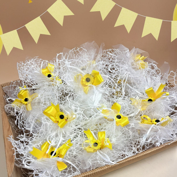 allestimento prima comunione santa cresima sacchettini a retina bianca confezionati come bomboniere con girasoli nastro confetti vassoio cesto di cartoncino